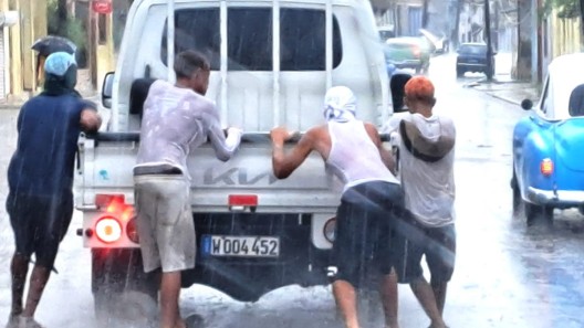 Jóvenes protagonizan peligroso juego diario en calles de La Habana bajo la lluvia